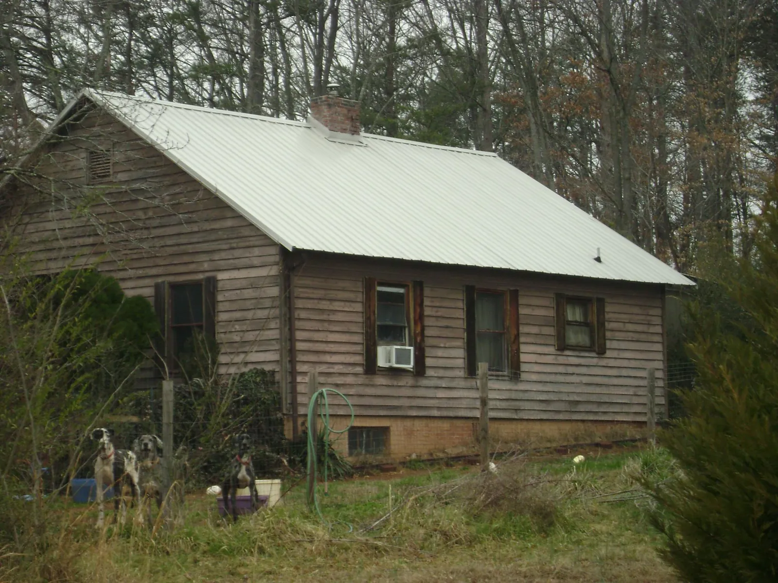White metal roof on an old wood sided farmhouse, from a Metal Roof Installation job in Wendell